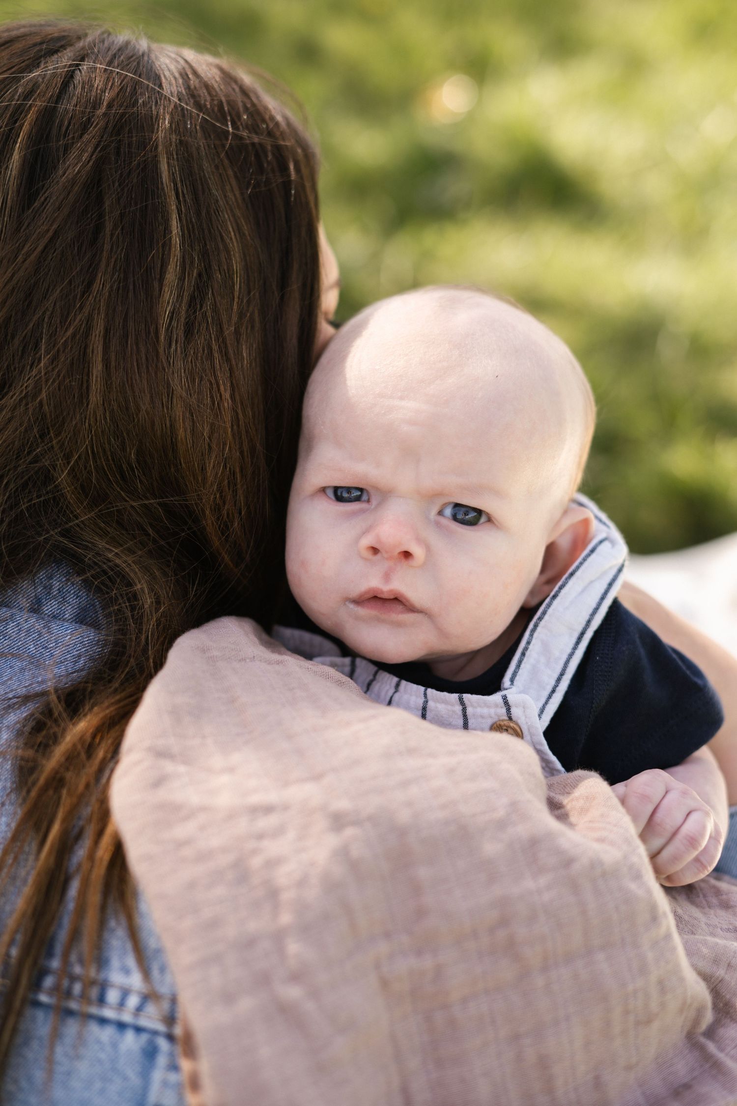 Sweet interaction between parent and baby against a soft blurred background.