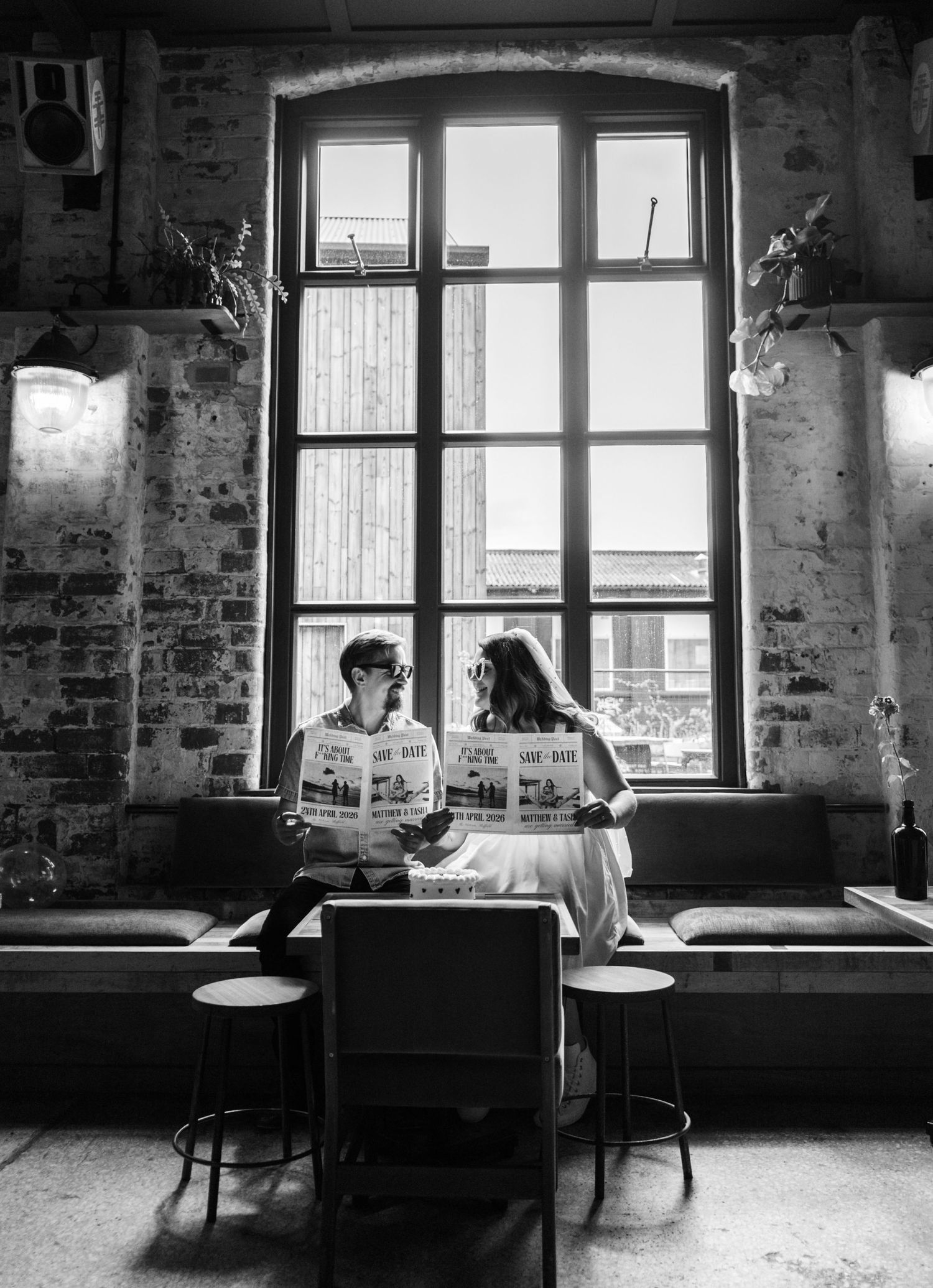 Black and white photo of a vintage-style room with large windows.