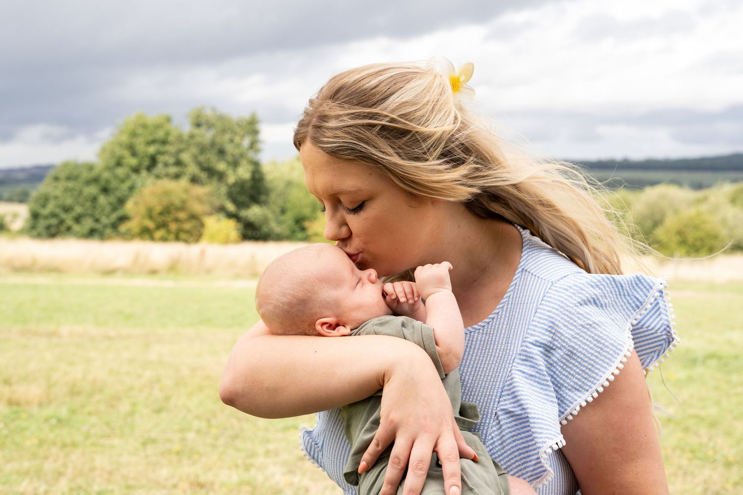 Family sharing joyful moment together in grassy field.