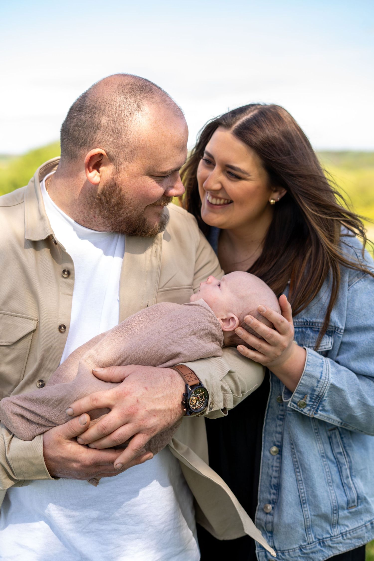 Family sharing loving moments together in casual outdoor setting.