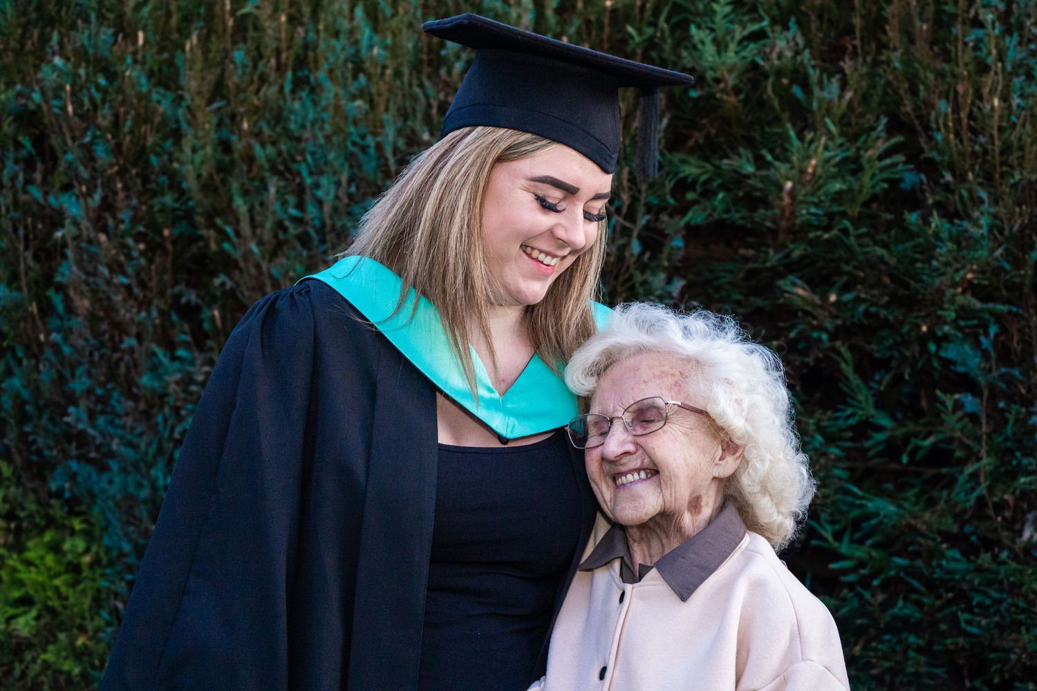 Candid moments of graduation celebration with graduate and elderly relative sharing joyful expressions.
