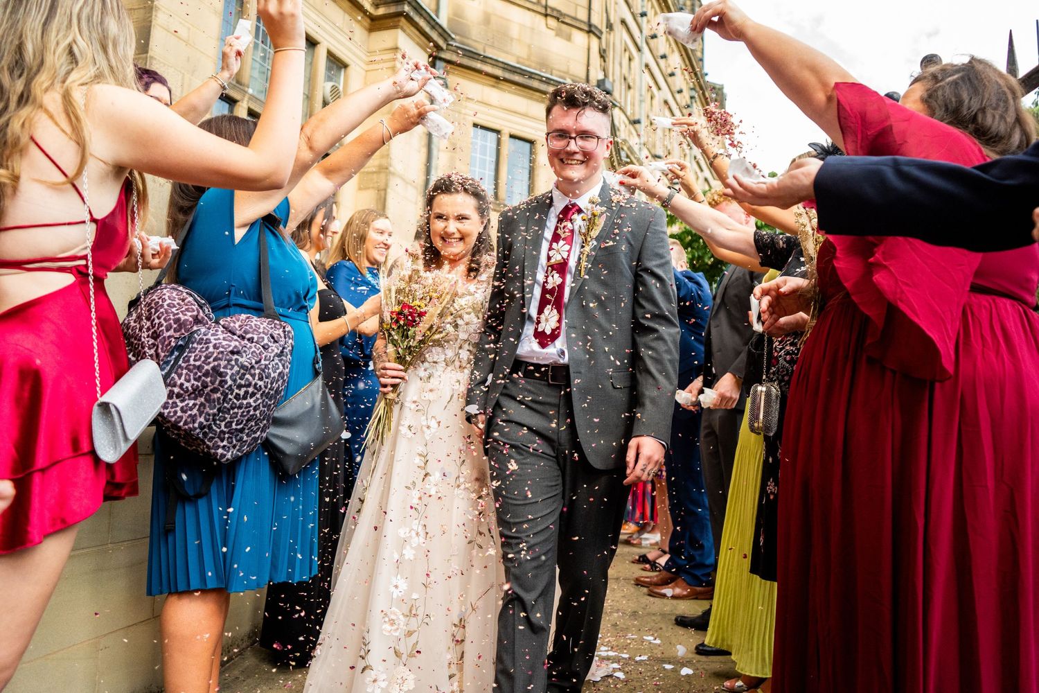 Wedding guests forming a celebratory tunnel for the newlyweds.