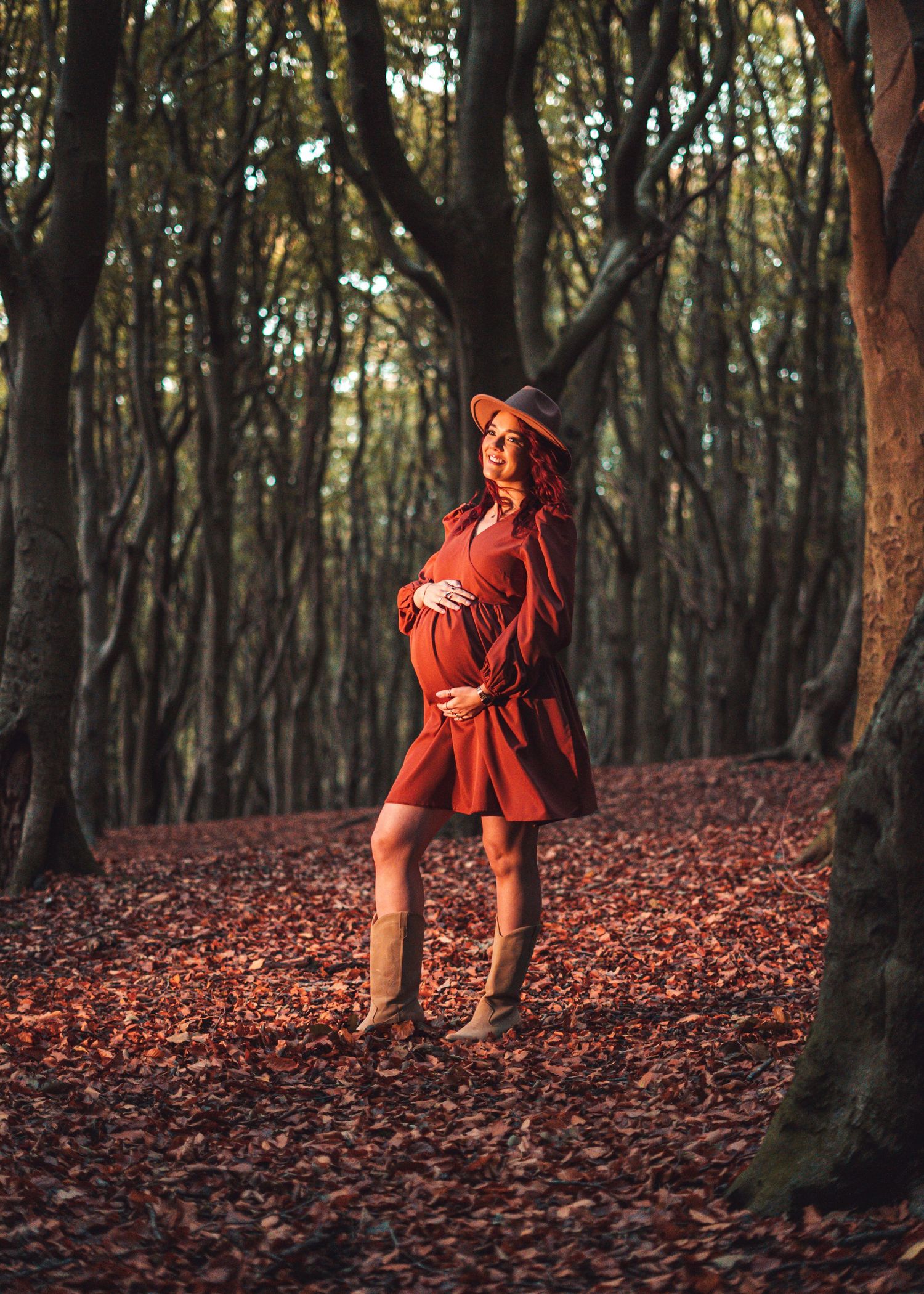 Artistic photo sequence of someone in red dress dancing through leaf-covered forest floor.