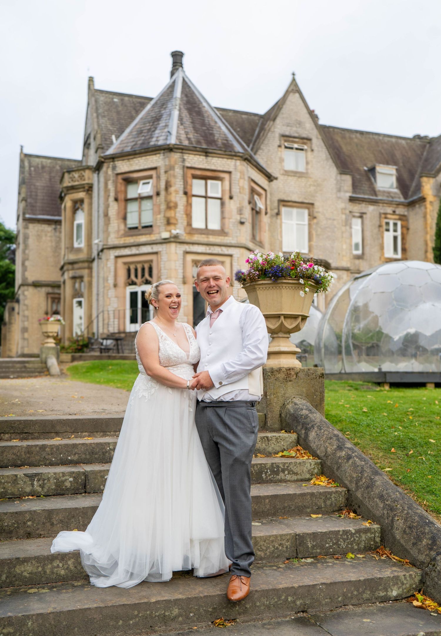 Wedding photography sequence outside a historic stone mansion with stone steps.