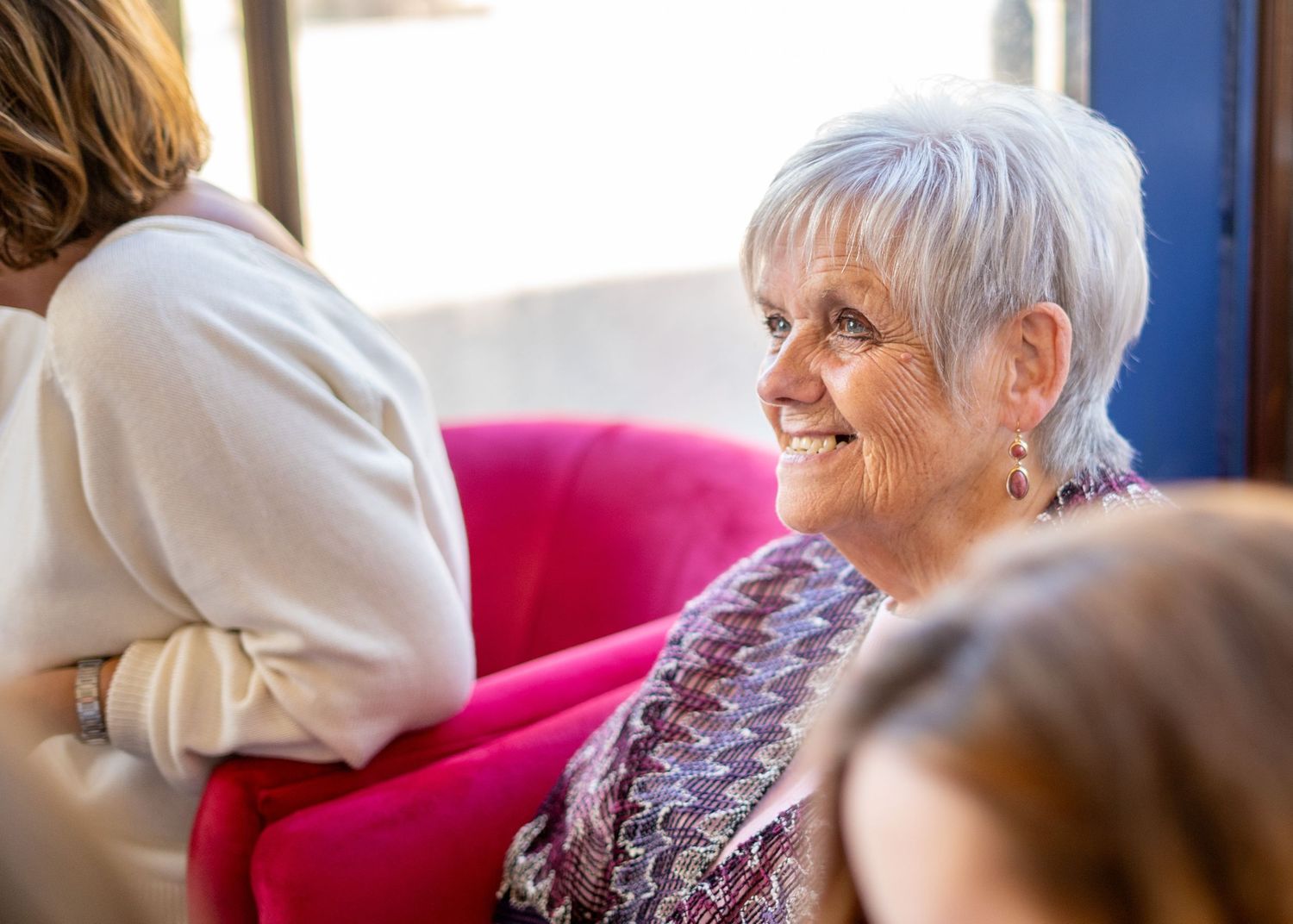 Guests enjoying conversation at a casual baby shower gathering.