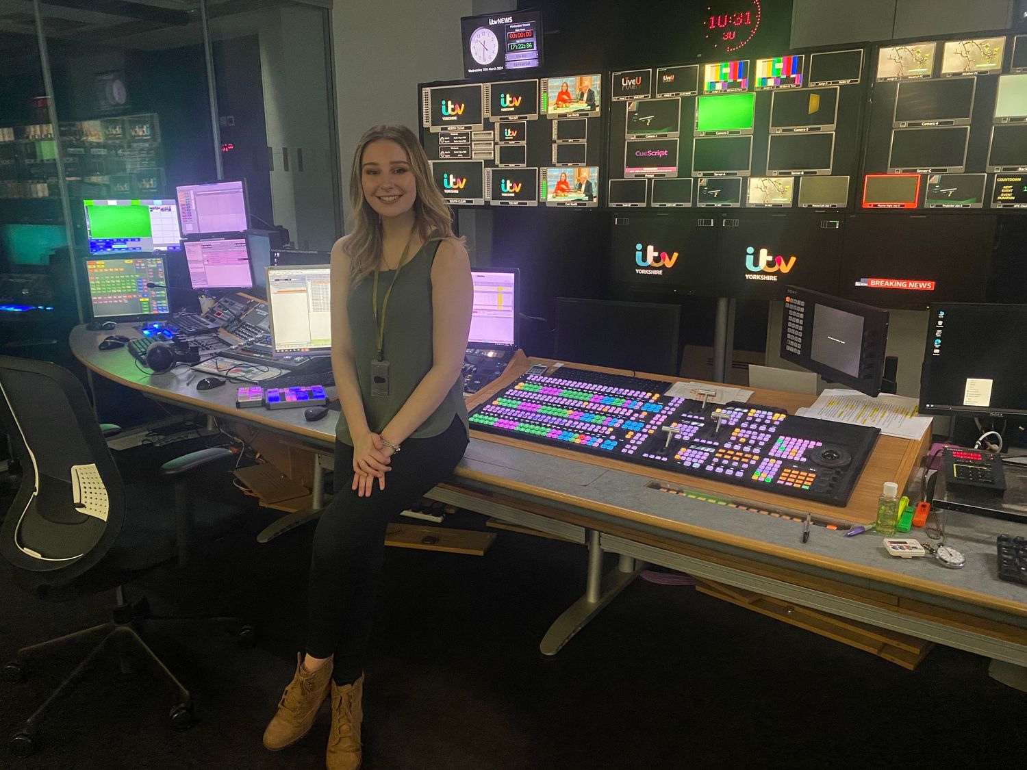 Professional broadcasting control room with TV production equipment and monitors displaying ITV logo.