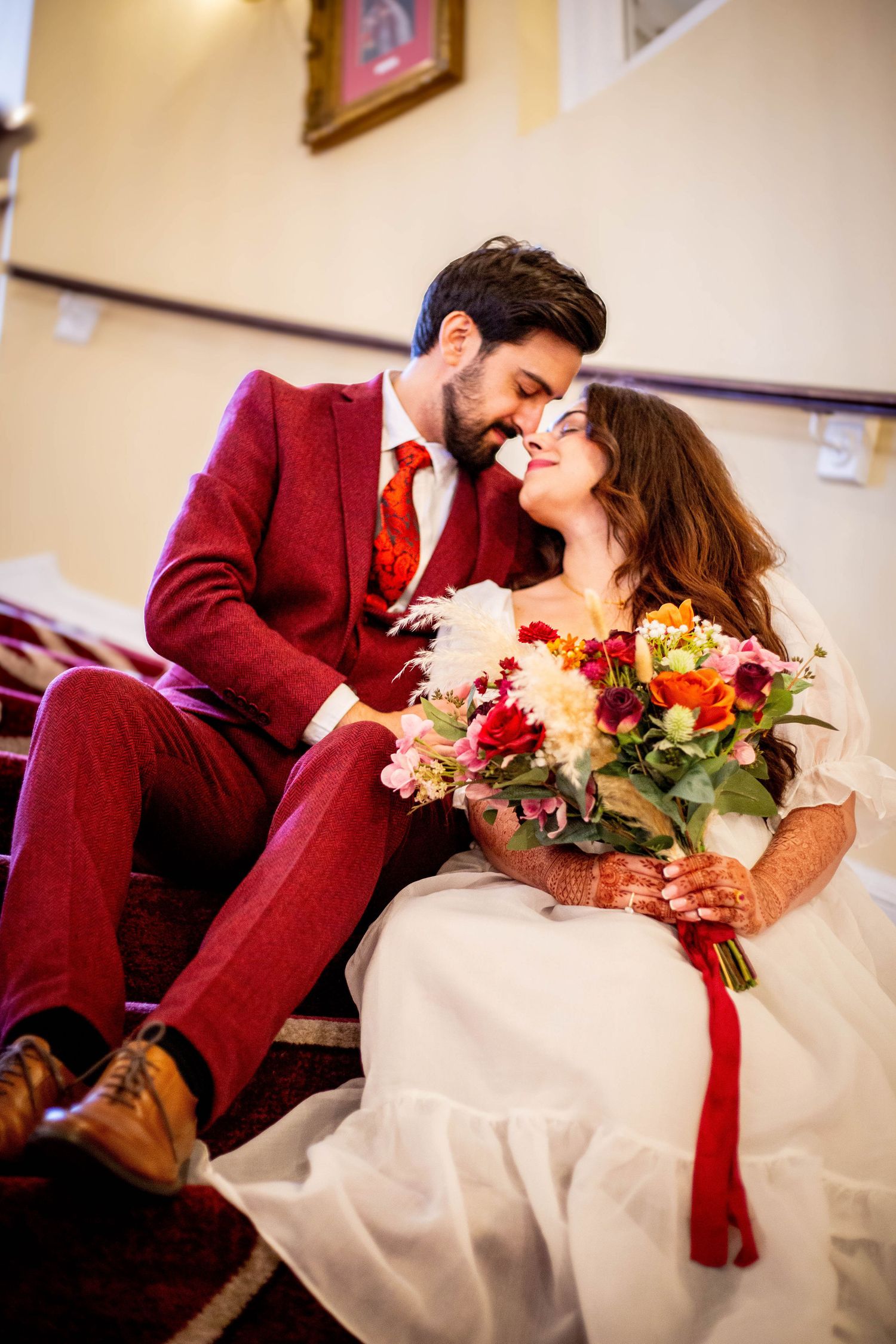 A romantic wedding moment captured in a burgundy and white color scheme.