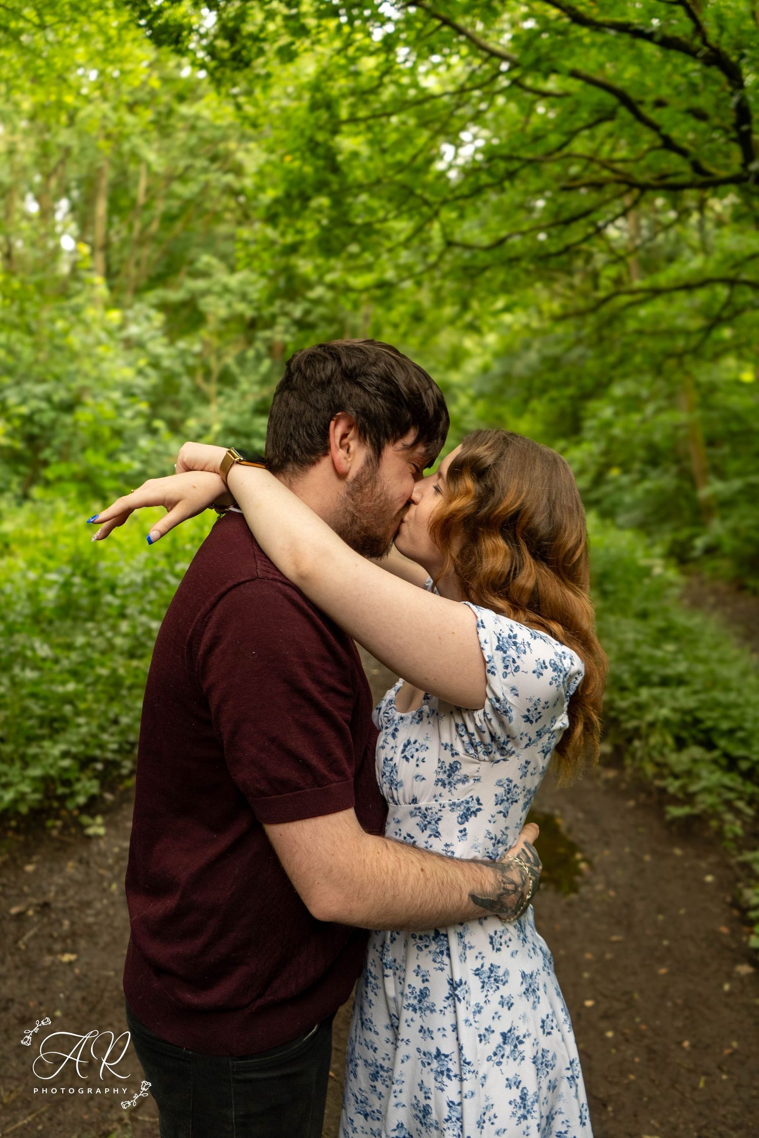 Intimate forest photography showing tender embraces and romantic moments on a wooded trail.