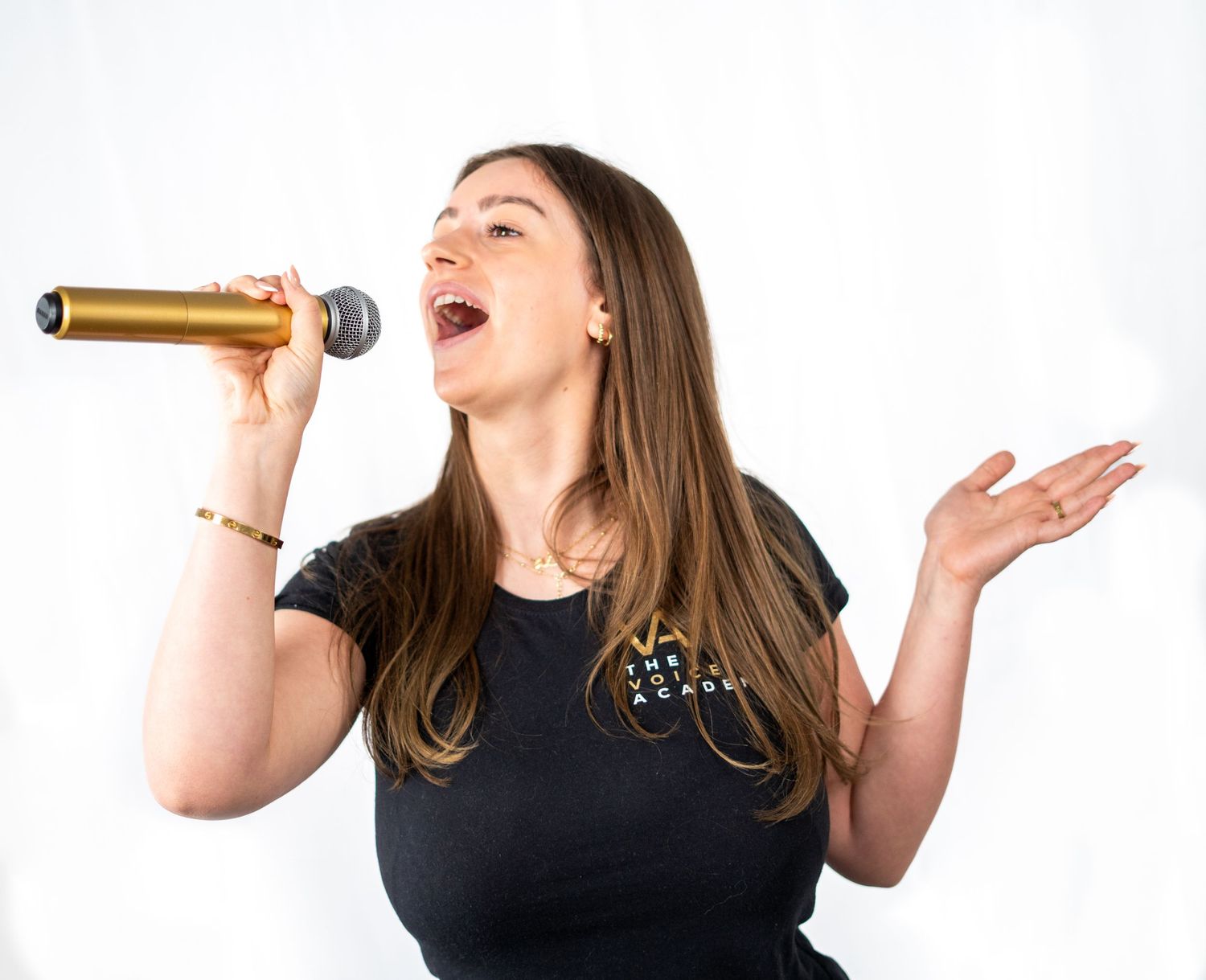 People in black shirts practicing vocal exercises and singing techniques.