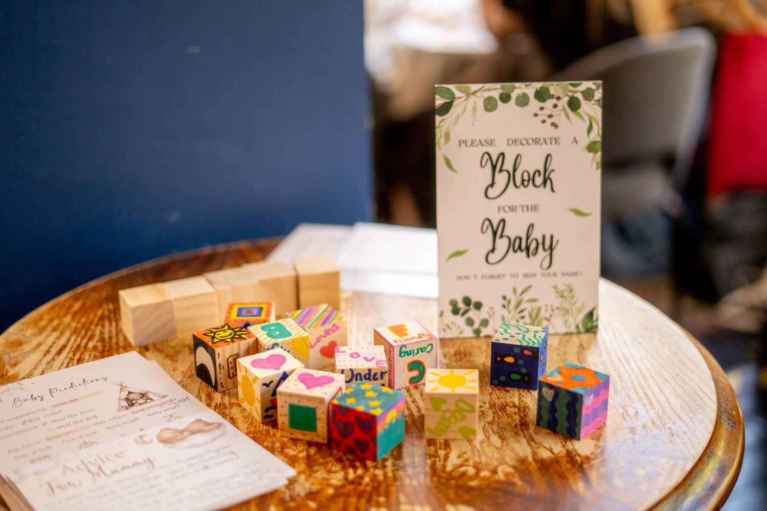 Baby shower table decorations with name cards and party favors on display.