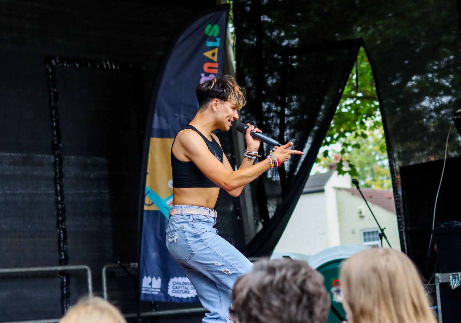 Audience watching performance at outdoor music festival.