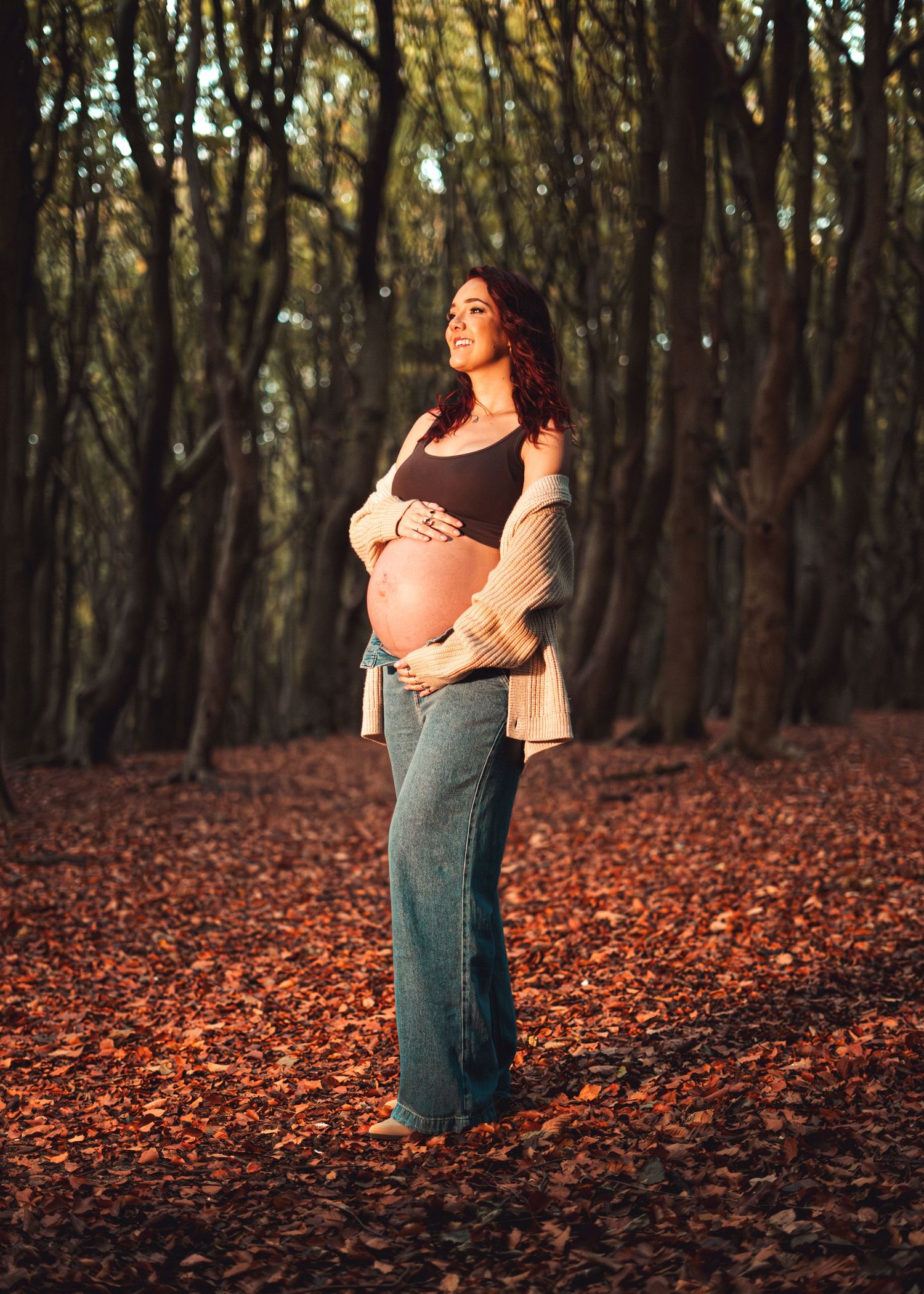 Expressive dance movements in autumn forest setting with fallen leaves.