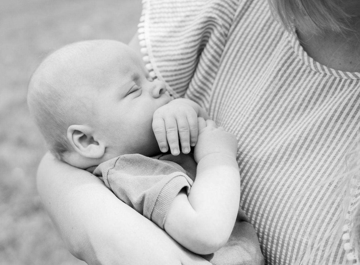 Black and white close-up of tender family moments with a baby.