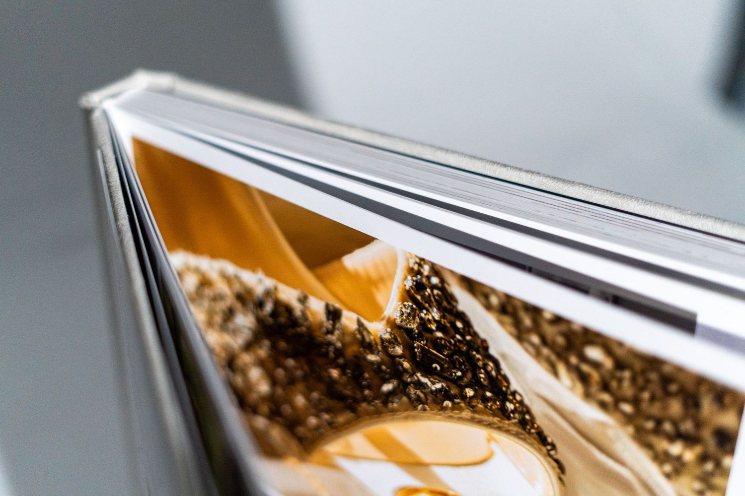 Macro shot of a metallic photo album binding showing detailed craftsmanship.