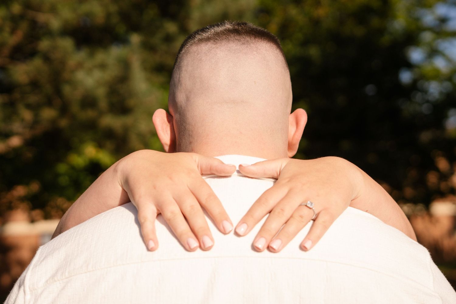 Close-up detail shots of hands tenderly touching shoulders.