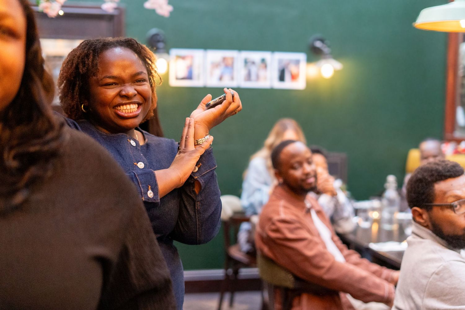 Guests reacting with excitement during a special announcement at an indoor gathering.