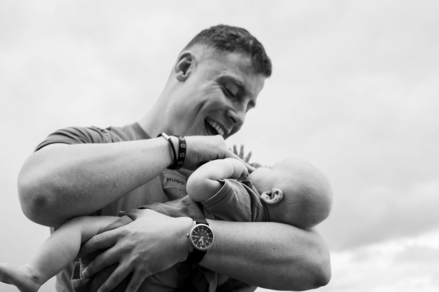 Black and white capture of intimate family moment outdoors.
