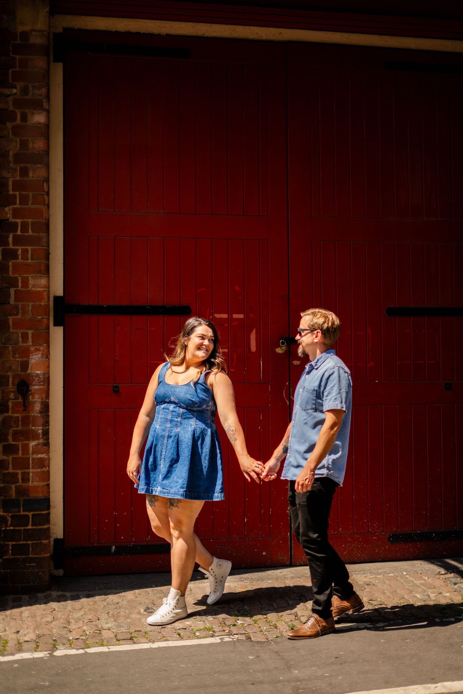 A sequence of photos against a red brick wall showing a romantic urban photoshoot.