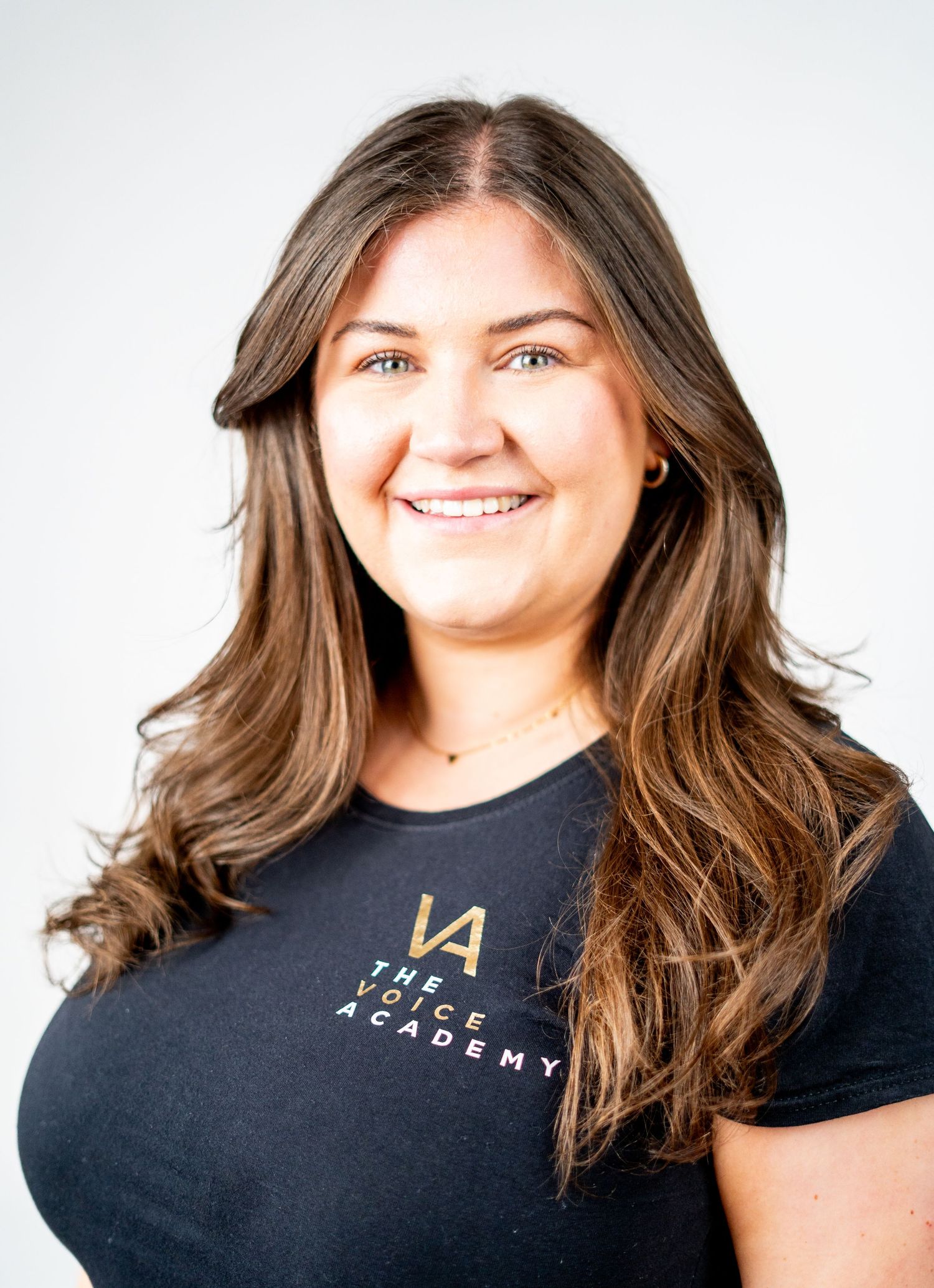 Studio portraits showing casual business style with text logo on black shirt.