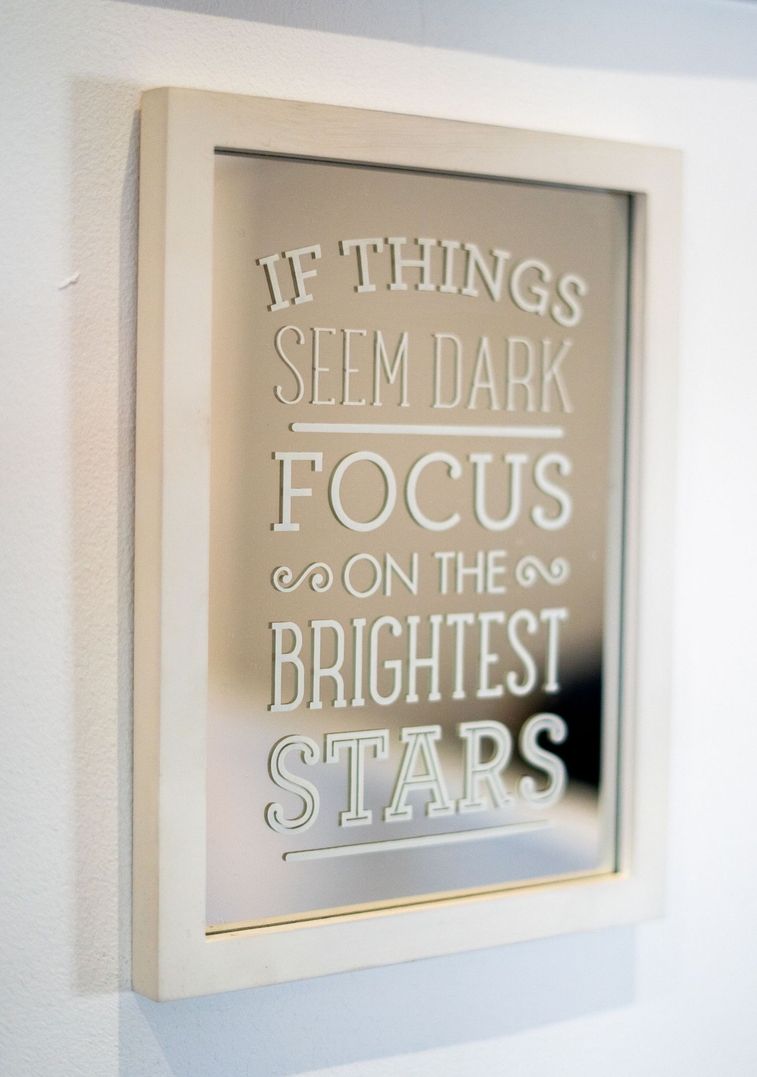 Motivational wall art reading 'If things seem dark focus on the brightest stars' in metallic finish.