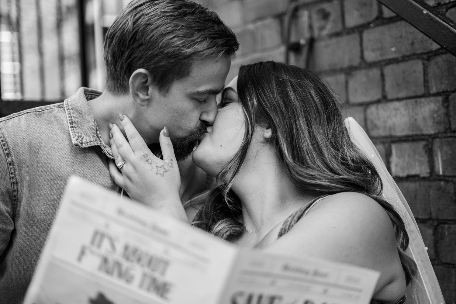 Close up of couple sharing romantic moment on brick building steps.