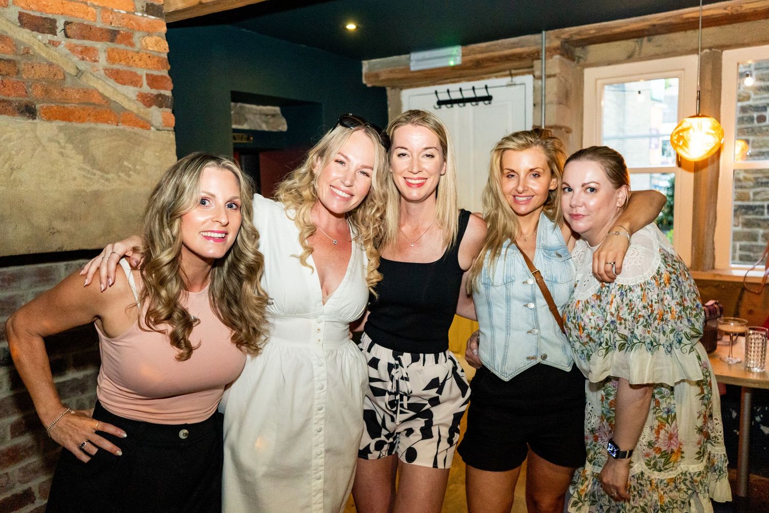 Friends gathered in casual restaurant setting for celebration.