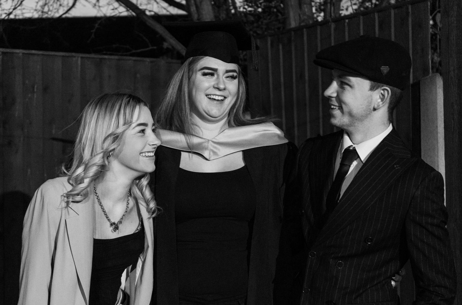 Candid graduation celebration moments captured in black and white photography.