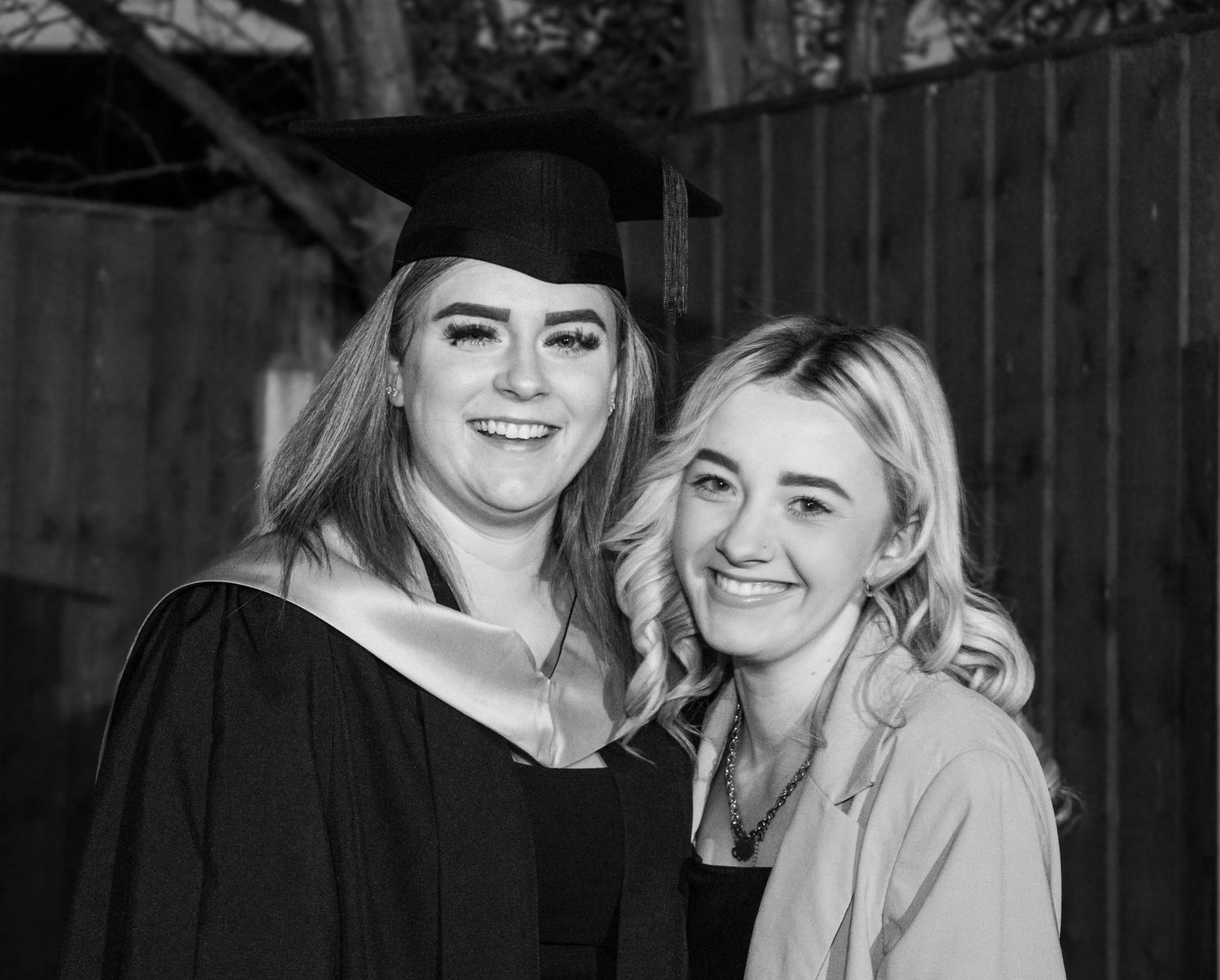 Black and white graduation portraits showing celebratory moments outdoors.