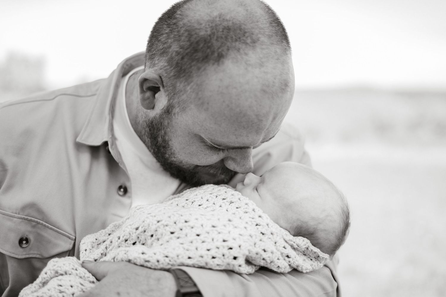 Black and white photos showing gentle moments of someone holding a small bundle.