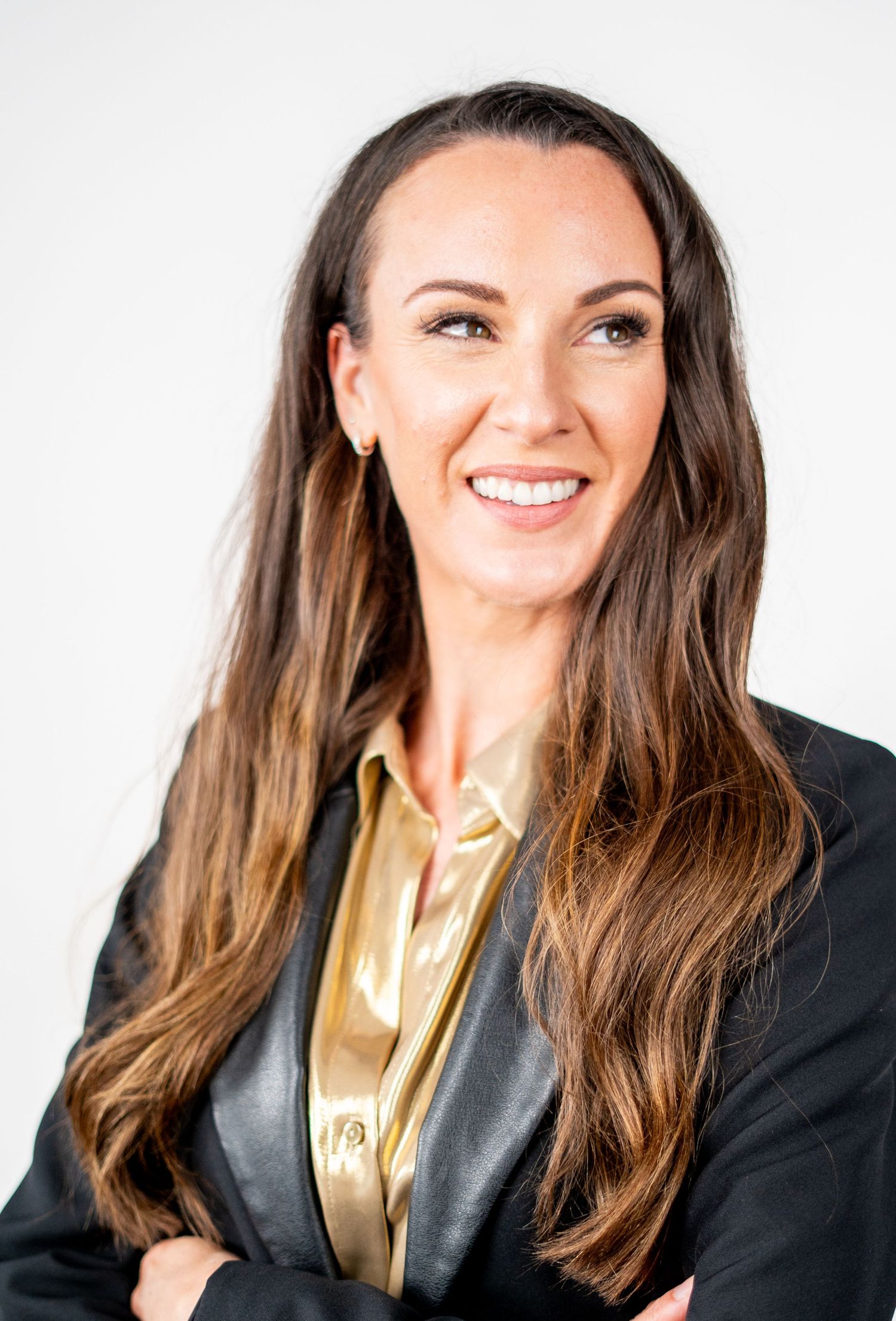 Professional headshots showing warm expressions in business attire against white backdrop.