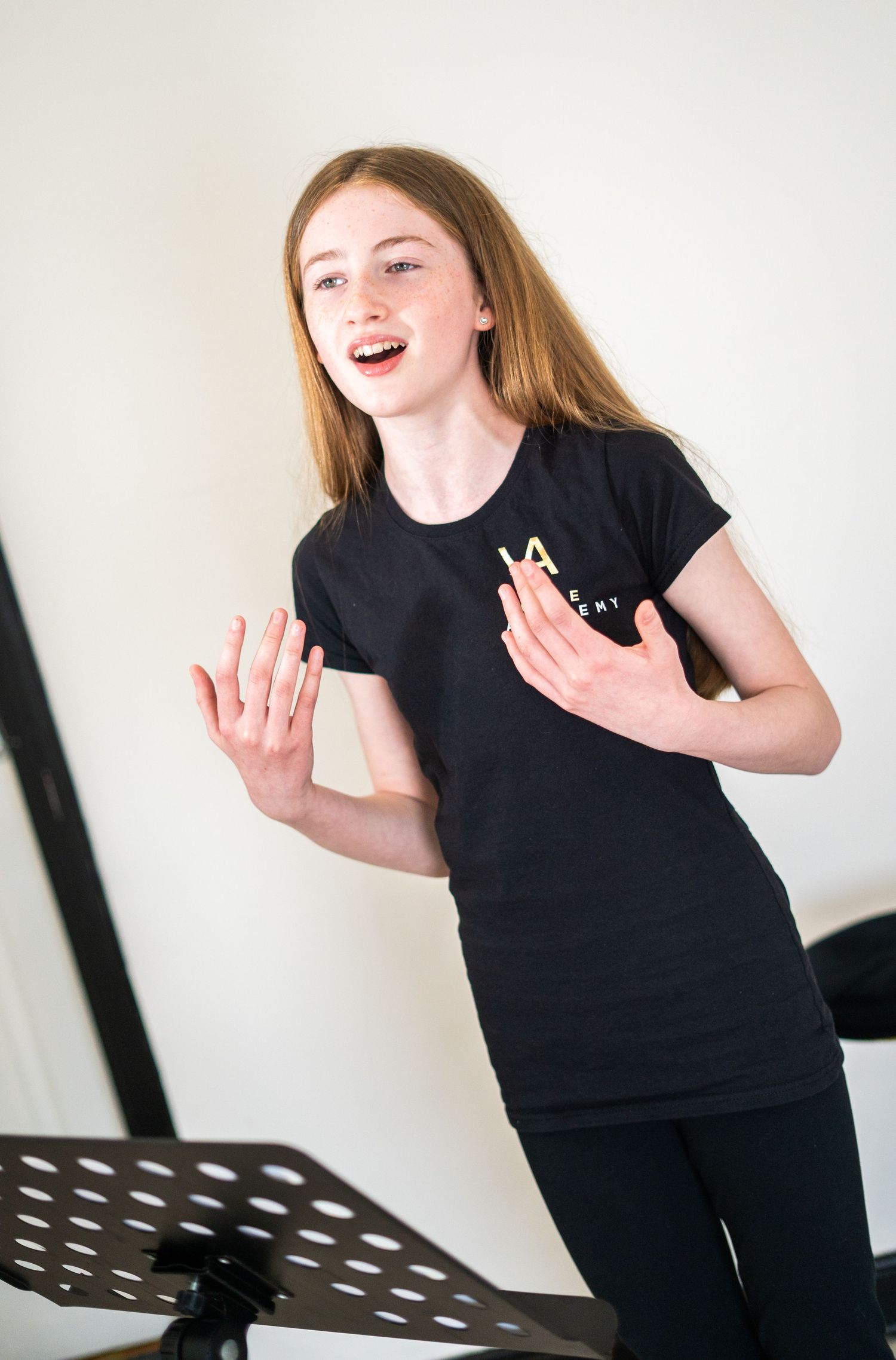 Enthusiastic student practicing vocal exercises in a music studio.