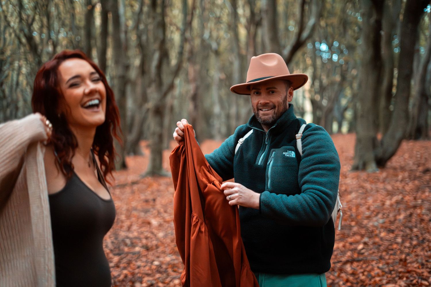 Candid moments captured during autumn forest photoshoot.