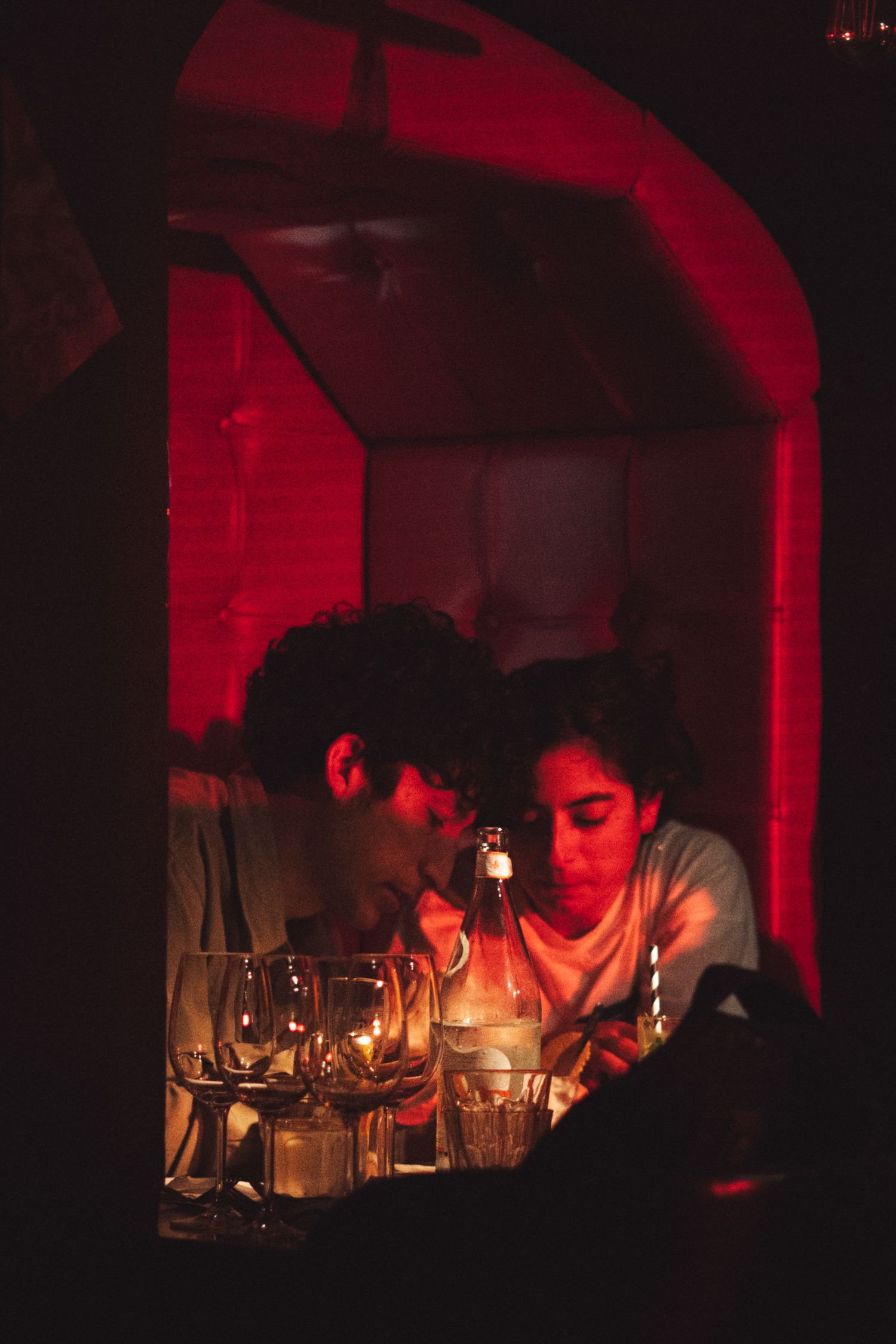Moody red lighting illuminates a dimly lit venue space creating a dramatic atmosphere.
