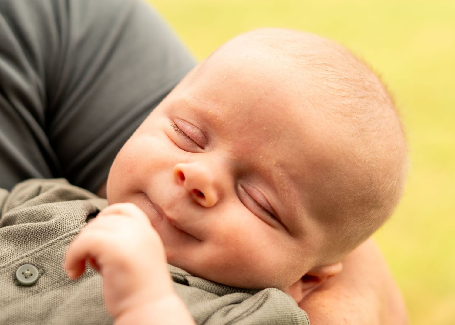 Close-up view of a sleeping baby in soft lighting.