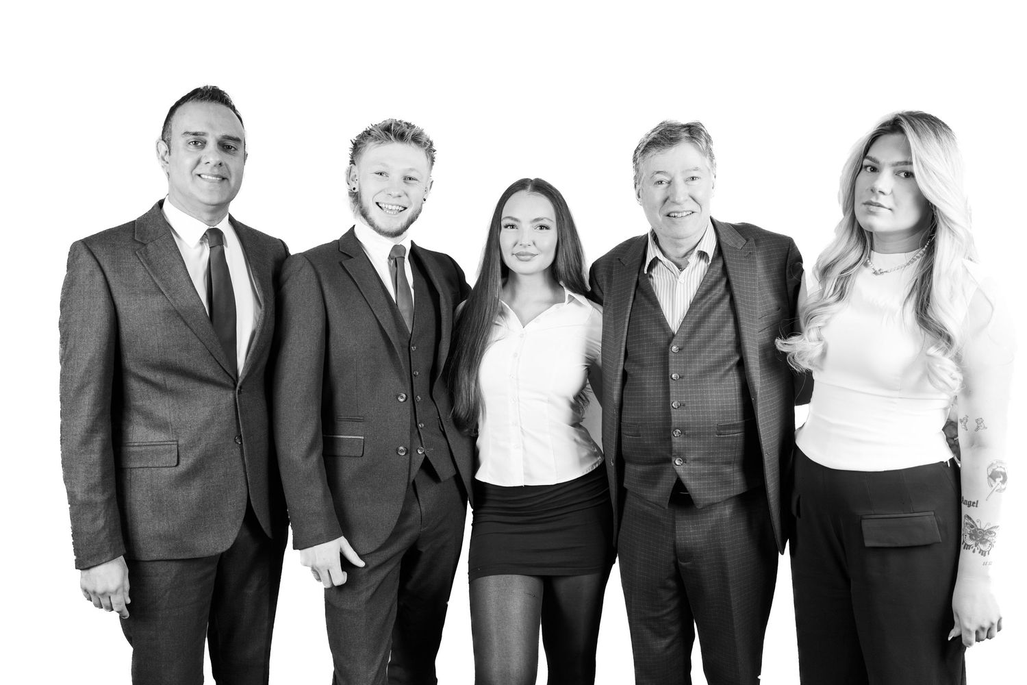 Professional group photo lineup against white background in business attire.