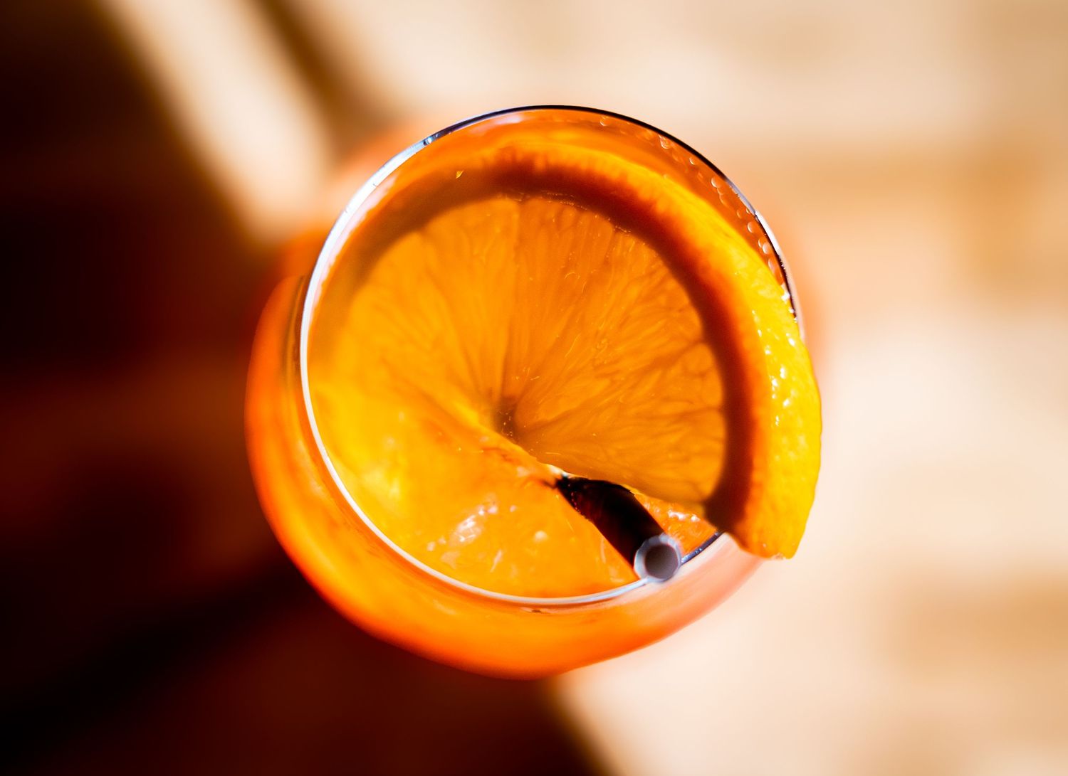 Close-up shots of orange citrus garnishes for cocktails in warm lighting.