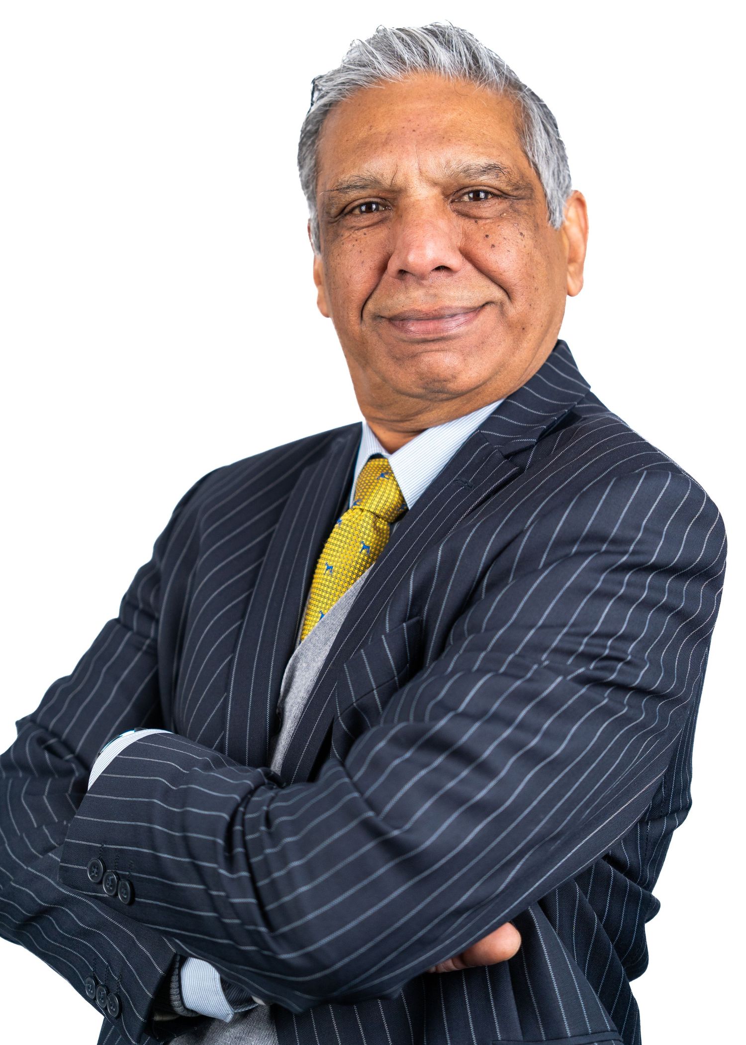 Business portrait series in pinstripe suit with yellow tie against white background.