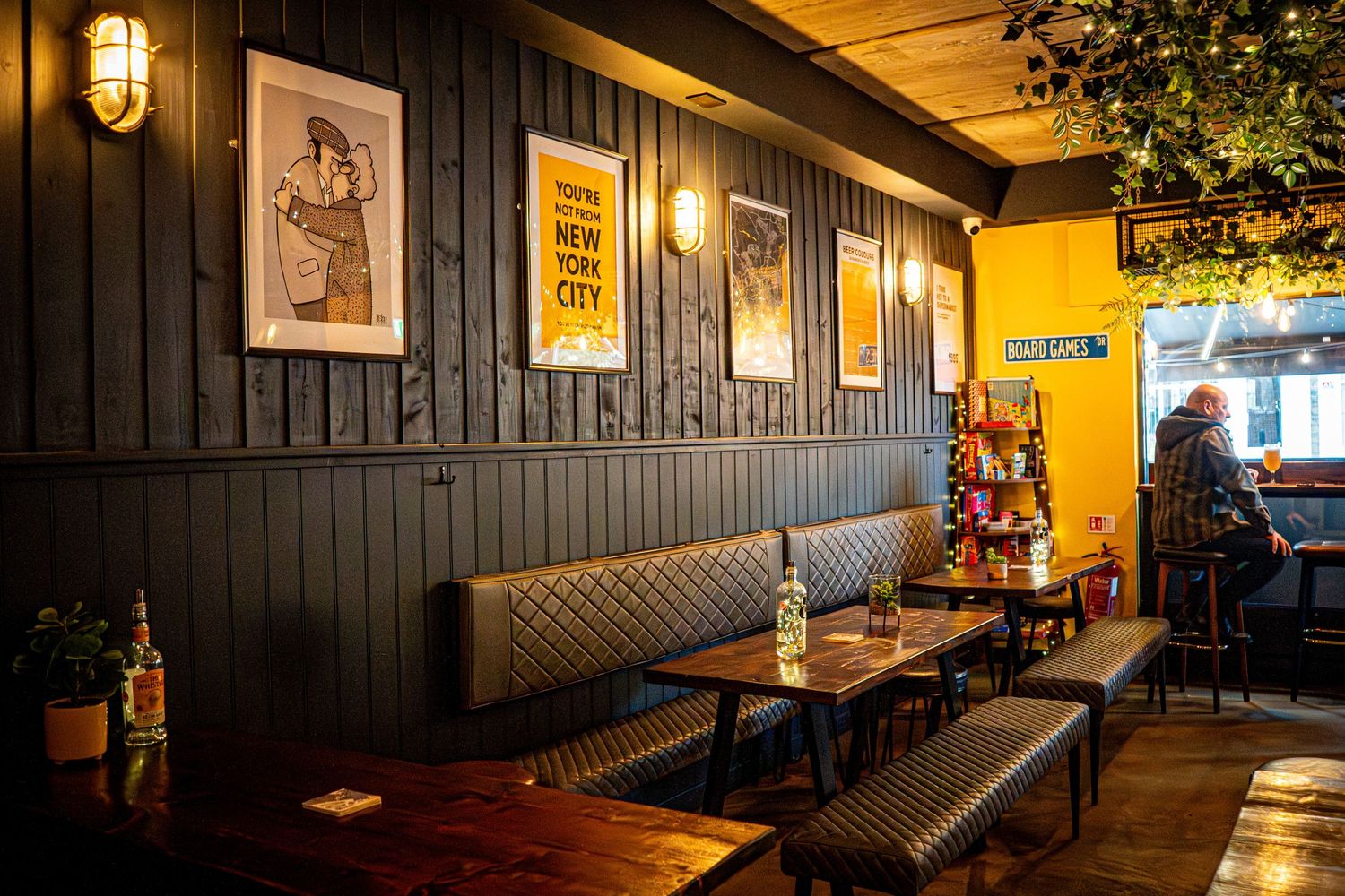 Cozy restaurant interior with dark wood paneling, booth seating, and ambient lighting.