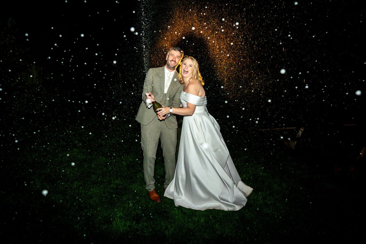 Romantic nighttime wedding photos with sparkling lights.