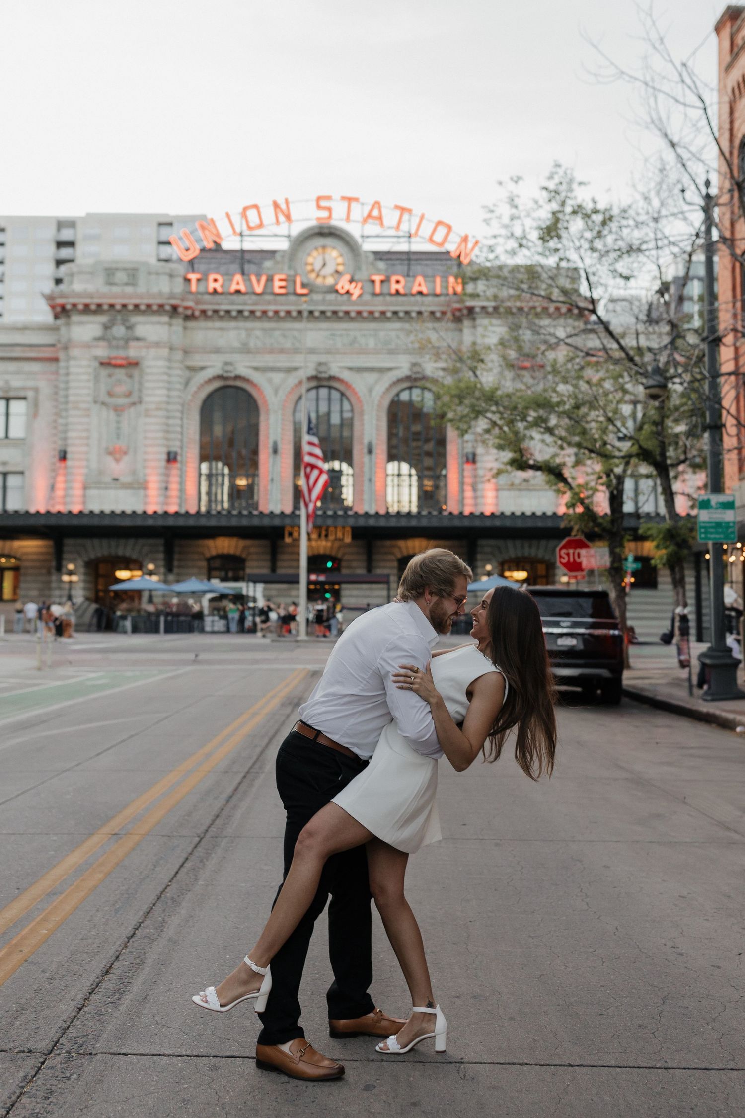 Couple embracing and laughing together in the middle of a city street