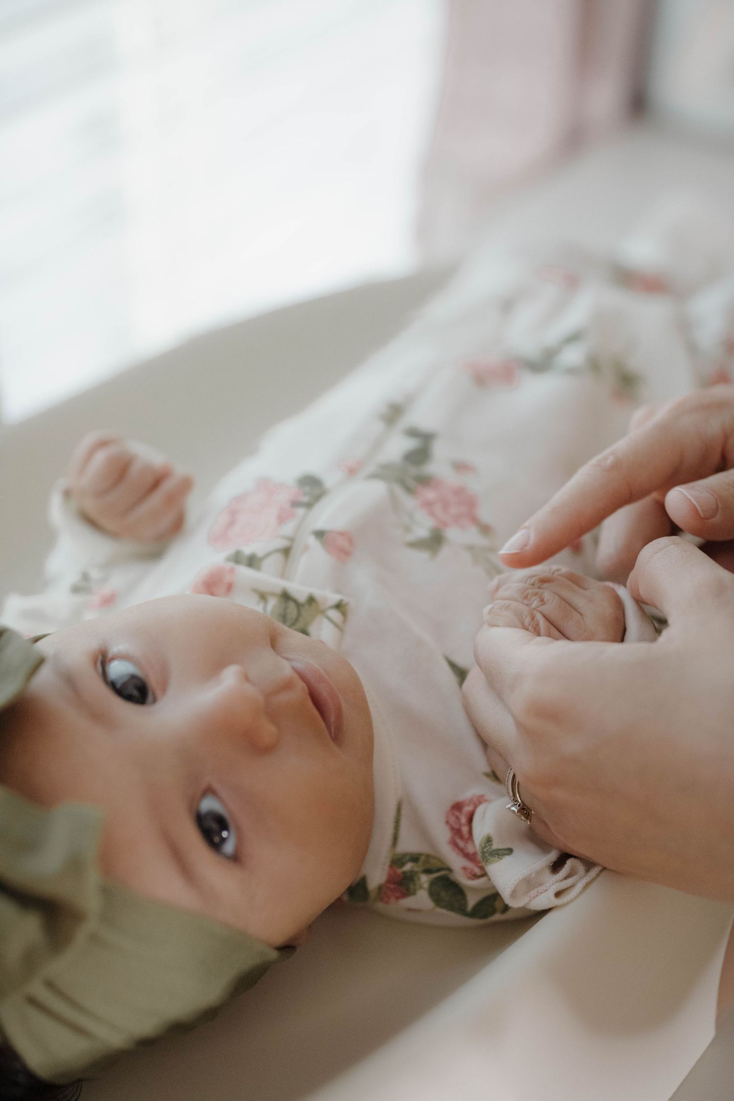 Newborn baby lying peacefully during an intimate maternity photography session, captured with a soft and natural style
