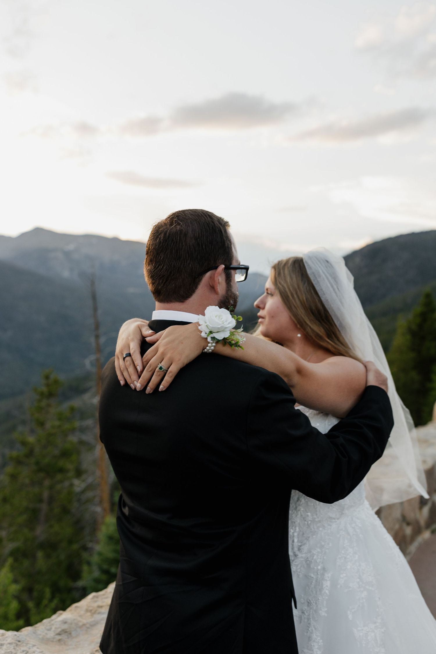 Bride and groom embracing with a mountain landscape in the background
