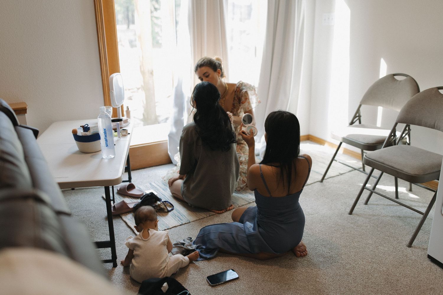 Wedding family and children gathered together during a quiet moment indoors