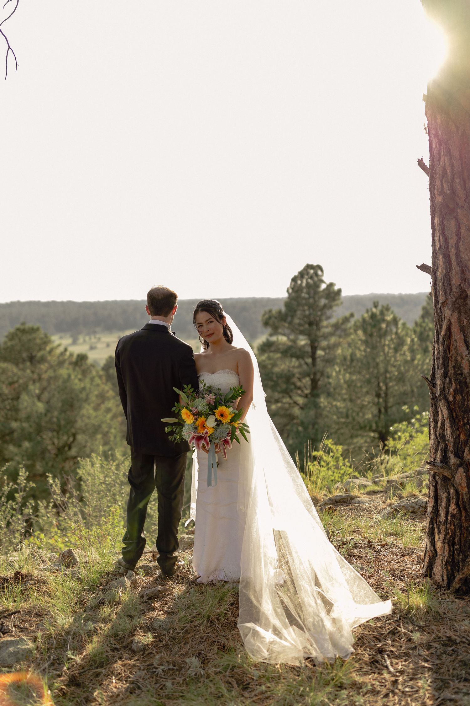 Newlywed couple embracing during a romantic golden hour portrait session in colorado by photography