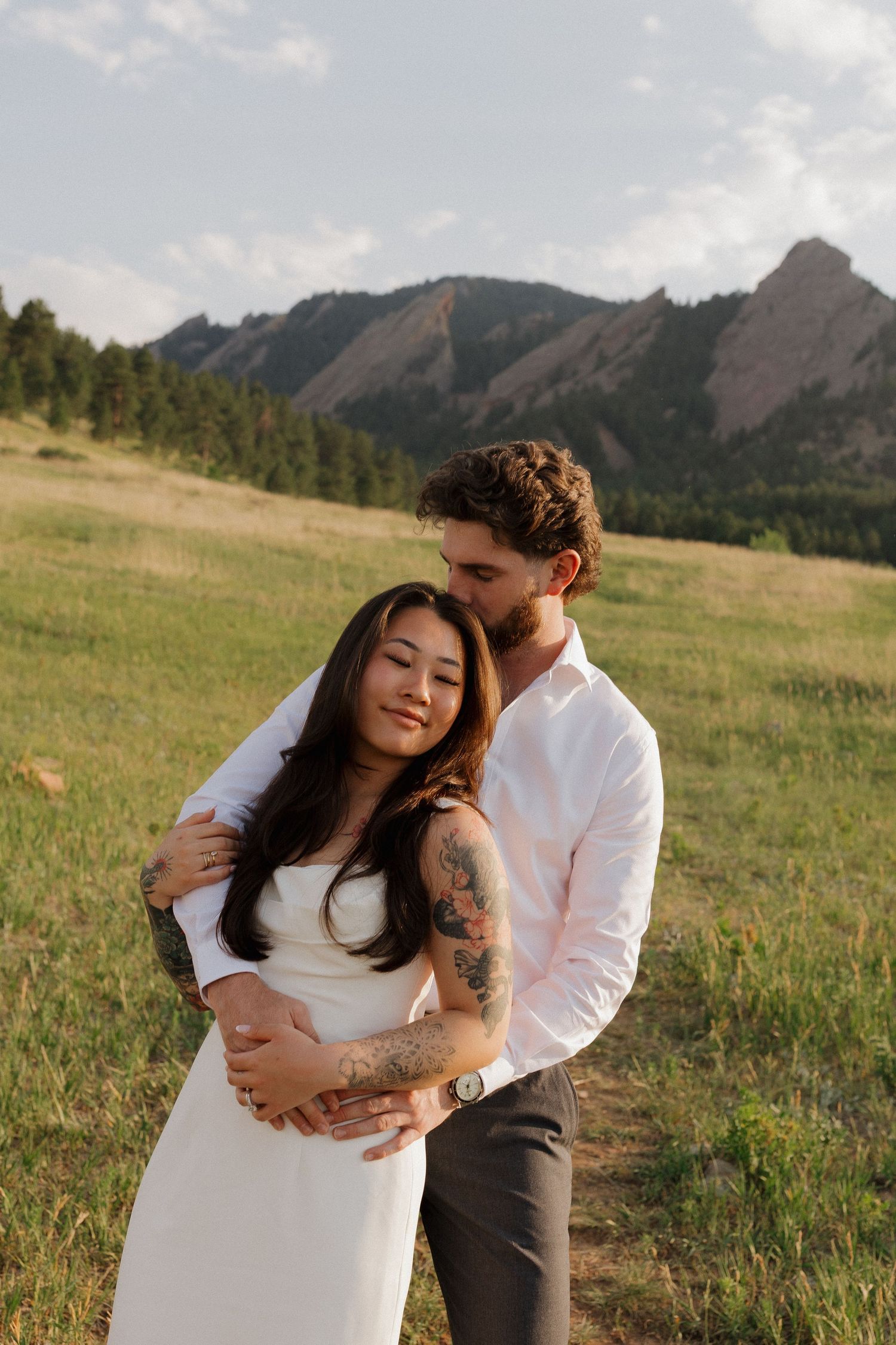 Couple embracing in a Colorado mountain meadow during a romantic and natural couples photography session