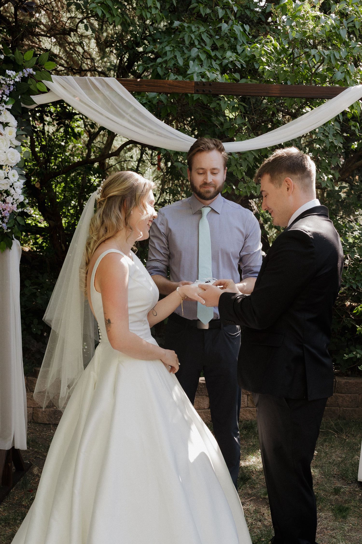 Bride and groom exchanging vows during their wedding ceremony outdoors