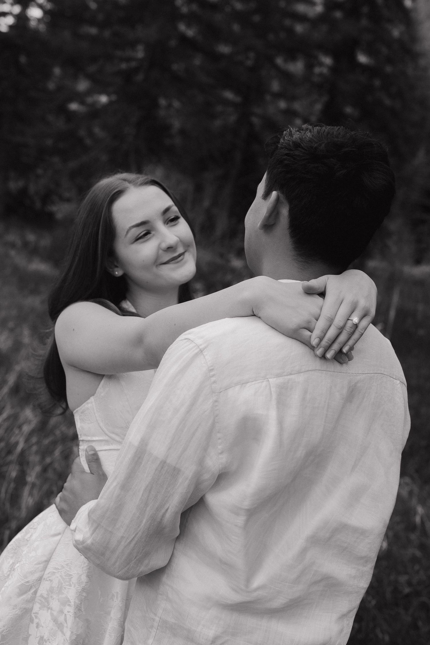 Couple embracing in a natural outdoor setting during an intimate couples photography session