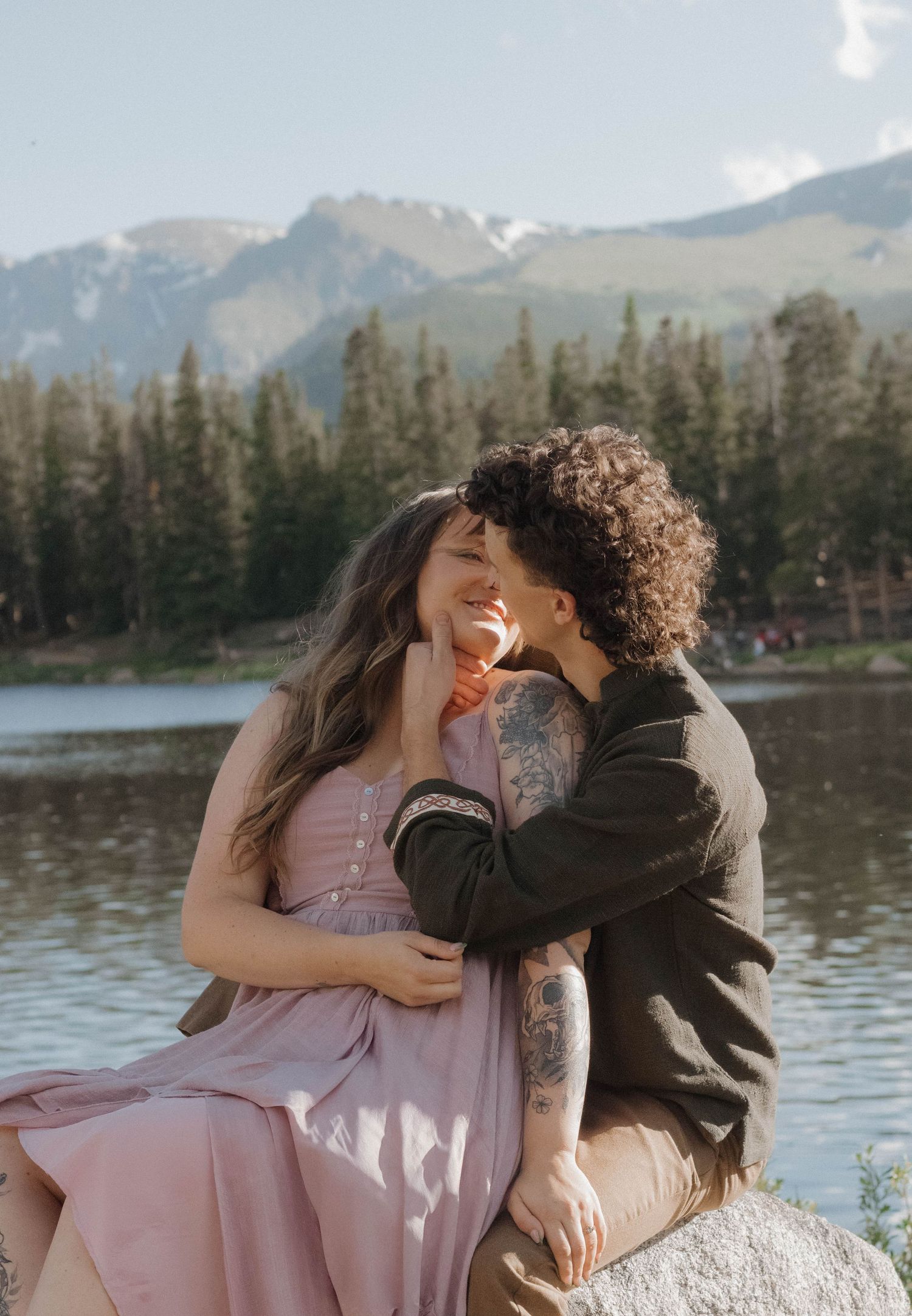 Couple embracing beside a mountain lake during a romantic and intimate couples photography session