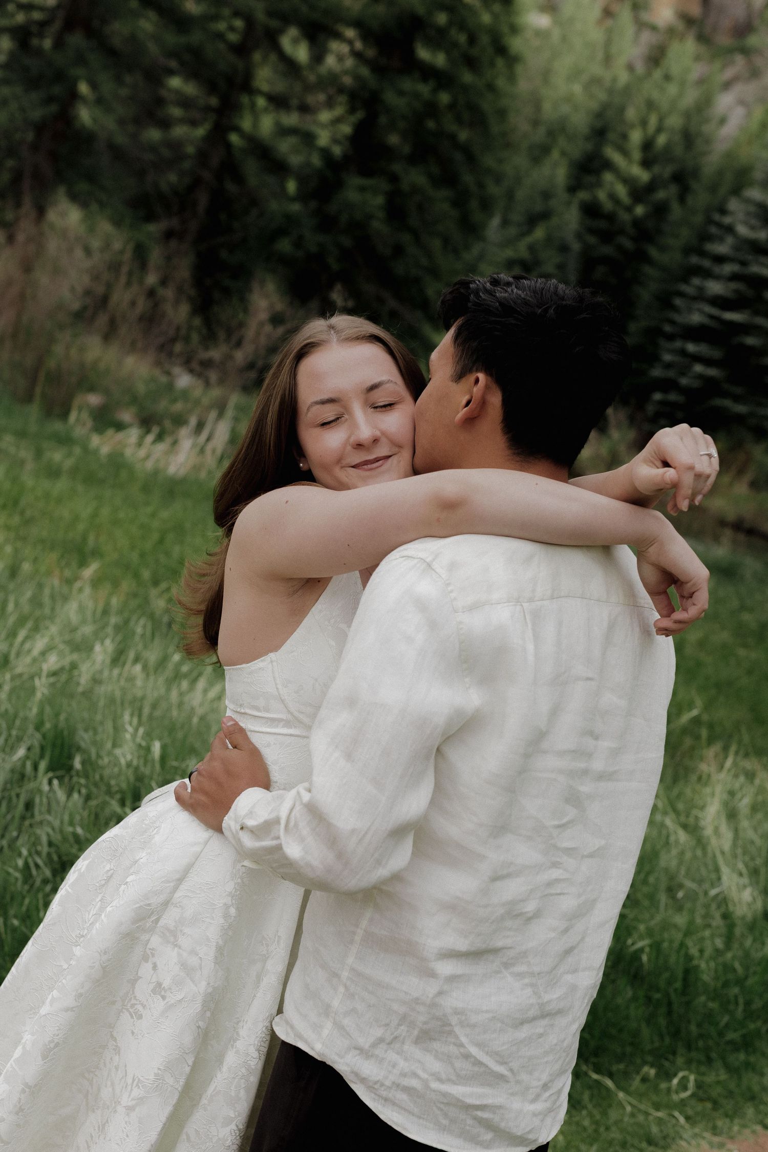 Couple hugging each other in a quiet forest setting during an intimate couples photography session