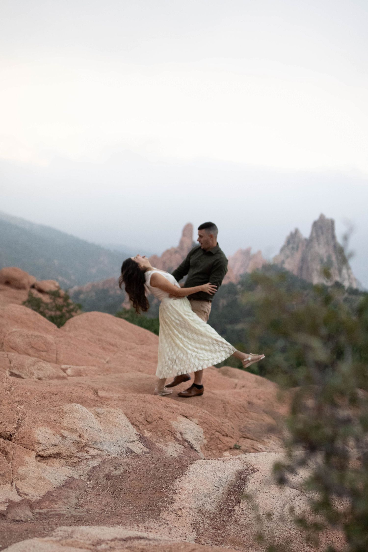 Couple walking together through a dramatic mountain landscape during a romantic outdoor couples photography session